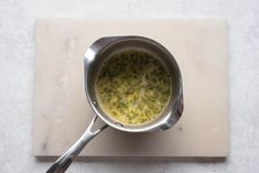 a pan filled with food sitting on top of a cutting board