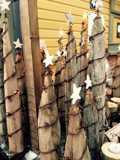 several wooden christmas trees with white stars on them