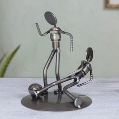 a metal figurine is standing on top of a table