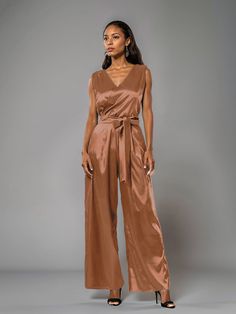 This soft satin jumpsuit features a flattering v-neck design, making it the perfect choice for mothers of the bride. Its dress pantsuit style provides comfort and elegance, while its high-quality material ensures a polished look. Stay stylish and comfortable on that special day with our jumpsuit. Elegant Party Jumpsuits And Rompers With Surplice Neckline, Elegant Party Jumpsuit With Surplice Neckline, Chic Satin V-neck Jumpsuits And Rompers, Satin V-neck Jumpsuits And Rompers For Party, Satin Jumpsuit With V-neck For Party, Satin V-neck Jumpsuit For Party, Party Satin V-neck Jumpsuits And Rompers, Chic Satin Jumpsuits And Rompers With V-neck, Solid V-neck Pantsuit For Night Out