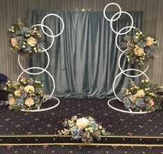 a wedding arch decorated with flowers and greenery