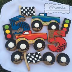 decorated cookies in the shape of cars and trucks