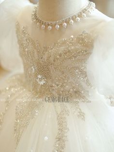 the back of a dress with pearls on it