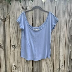 This Is A We The Free By Free People Scoop Neck, Short Sleeve Tea. Size Large. The Color Is A Periwinkle Blue. It Is 100% Cotton And Very Soft Fabric. It Has Raw Edge To-The Sleeves And Neckline. Casual Scoop Neck Short Sleeve Top For Everyday, Casual Short Sleeve Scoop Neck Top For Everyday, Everyday Cotton Short Sleeve Top With Scoop Neck, Cotton Scoop Back Top For Summer, Spring Loungewear Tops With Scoop Back, Casual Summer T-shirt With Scoop Back, Casual Everyday Top With Scoop Back, Spring Scoop Back Tops For Loungewear, Scoop Back Tops For Spring Loungewear