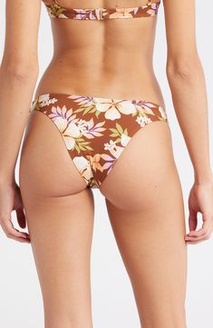 Your style will be blooming while lounging poolside in these cheeky bikini bottoms designed with a tropical floral pattern. Cheeky back coverage Lined 78% polyamide, 22% elastane Hand wash, line dry Imported Beachy Tie-side Bottoms With Floral Print, Beachy Floral Print Tie-side Bottoms, Summer Floral Print Bottoms For Sunbathing, Beachy Floral Print Bottoms For Vacation, Beachy Floral Print Vacation Bottoms, Beachy Bottoms With Floral Print For Poolside, Beachy Floral Print Bottoms For Poolside, Tropical Tie-side Bottoms With Floral Print, Floral Print Bottoms For Beach Party Vacation