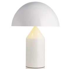 a white table lamp with a black base and a light bulb on the top of it