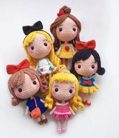 a group of knitted dolls sitting next to each other