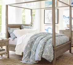 a bedroom with a four poster bed and dressers