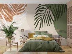 a bedroom decorated in green and white with palm leaves on the wall