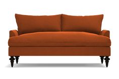 an orange couch sitting on top of a white floor