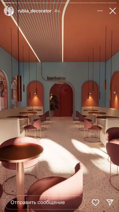 the interior of a restaurant with pink chairs and tables