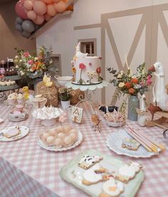 a table topped with lots of food and desserts