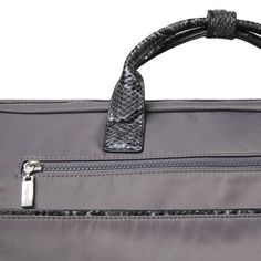 the handle of a gray and black bag with snakeskin pattern on it's sides