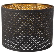 a black lamp shade with gold circles on it