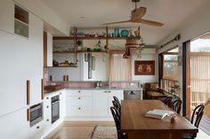 an open kitchen and dining room with sliding glass doors