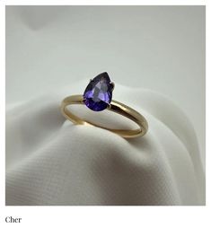 The Cher Ring (Solitaire) This ring was inspired by the one and only, Cher.  Just like it's namesake, it stands alone in all it's proud and unique beauty.  This deep and moody purple Sapphire, pear cut Solitaire radiates strength and indipendence. Product Info: Natural (Untreated) Genuine Violet Purple Sapphire  .84 Ct.  Pear Cut  Solitaire   2mm - 18K Gold Band SI Clairty Please note: All our Sapphire gemstones are genuine and natural, meaning they were mined from the earth and left untreated. Timeless Purple Rings Perfect For Gifts, Timeless Purple Rings As Gifts, Timeless Purple Rings For Gifts, Classic Purple Sapphire Ring For Wedding, Classic Purple Ring As Gift, Classic Purple Sapphire Wedding Ring, Classic Purple Rings As Gift, Classic Purple Sapphire Promise Ring, Classic Purple Sapphire Ring With Prong Setting