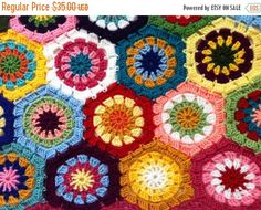 a crocheted blanket with multicolored circles in the center and on top