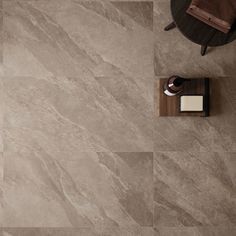 a tile floor with a table and chair next to it