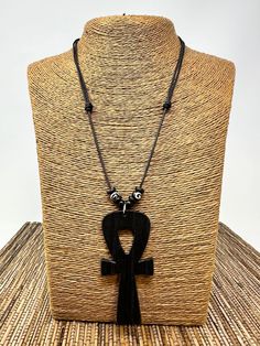 Black Ankh Necklace Pendant. Handmade Black Ankh Wooden Pendant. Unisex Design. Wooden Ankh Pendant. Adjustable Necklace with Sliding knots. Adjust from 18" Inches up to 30" Inches Around the Neck Meaning of Ankh Cross: ancient symbol of life in Egypt Ankh Pendant Dimensions: 3" Inches Long FAST & FREE SHIPPING!  Visit my Etsy Shop to see more Handmade Africa Jewelry! At Freedom Lifestyle Jewelry you will find a variety of Africa Necklaces and Africa Earrings. Click here to see more designs: htt Black Ankh Jewelry For Gifts, Black Ankh Spiritual Jewelry, Adjustable Ankh Black Necklace, Symbolic Ankh Necklace Adjustable, Handmade Ankh Symbolic Necklace, Symbolic Ankh Necklace, Bohemian Ankh Necklace For Festivals, Handmade Ankh Necklace For Festivals, Adjustable Black Amulet Necklace