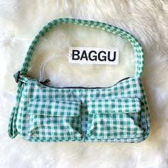 New With Tag. Color: Green Gingham A Baguette Style Purse With Two External Flap Pockets For Easy Access To Your Essentials. - Two Exterior Flap Pockets With Magnetic Closure - Measures 4.7" H 11" W 3" D - Adjustable 29.5" Quilted Strap - Recycled Heavyweight Nylon With Recycled Ripstop Lining - Machine Washable ** First Time On Poshmark? Use Code Emmmamercer When You Create Your Poshmark Account To Receive A $10 Credit Toward Your First Purchase. ** Trendy Rectangular Shoulder Bag For Picnic, Trendy Tote Shoulder Bag For Picnic, Gingham Pouch Bag For Daily Use, Casual Green Bag For Picnic, Casual Square Shoulder Bag For Picnic, Casual Green Bag For Picnics, Gingham Shoulder Bag For Daily Use, Summer Plaid Bags For Everyday Use, Rectangular Plaid Shoulder Bag For Picnic