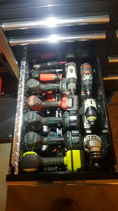 a drawer filled with lots of different types of drillers and screwdriver's