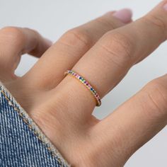 One of the biggest trends of the moment is rainbow, or multicolored jewelry! The colors are so vibrant, and truly matches with whatever you have on! Sweet, simple, and dainty eternity band. Perfect for a minimalist look, or for stacking. - - - D E T A I L S - - - * Made of 925 Sterling Silver * We use a THICK, DURABLE 14k Gold or Rhodium plating - for a piece that will last you years to come! * VERY HIGH QUALITY * Available in sizes 4, 5, 6, 7, 8, 9, or 10 * Features stones throughout the entire Trendy Multicolor Open Ring Jewelry, Multicolor Open Ring Stackable Rings As Gift, Rainbow Stackable Cubic Zirconia Rings, Rainbow Cubic Zirconia Stackable Rings, Rainbow Stackable Rings In Cubic Zirconia, Multicolor Stackable Cubic Zirconia Jewelry, Adjustable Multicolor Crystal Promise Ring, Adjustable Multicolor Stackable Rings, Rainbow Cubic Zirconia Stackable Jewelry