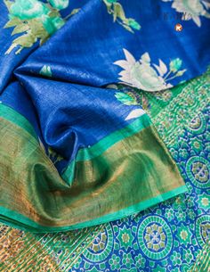 Make a statement with this Blue Pure Tussar saree. The exquisite flower print and zari border add a touch of elegance to this quirky and fun saree. Perfect for any occasion, this saree is sure to turn heads and make you stand out from the crowd. Don't miss out on this unique and playful piece! Festive Tussar Silk Pre-draped Saree With Printed Border, Traditional Art Silk Pre-draped Saree With Floral Print, Traditional Pre-draped Saree With Floral Print For Eid, Traditional Floral Pre-draped Saree For Eid, Traditional Multicolor Pre-draped Saree With Floral Print, Festival Art Silk Pre-draped Saree With Printed Motifs, Blue Bohemian Dupatta With Printed Motifs, Green Floral Print Saree For Navratri, Bohemian Blue Dupatta With Printed Motifs