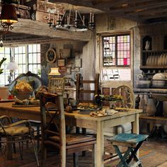 an old fashioned kitchen and dining room with lots of clutter