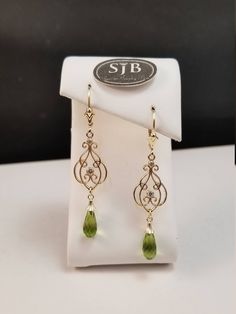 "Bright green Peridot faceted briolette dangle earrings. Set in 14kt Yellow Gold bell caps, with scallop-edged decorative details and large symeterical filigree dangle all hanging from a fleur-de-lis leverbacks. Measures approximately 2\" long. August Birthstone. Pantone Green 2017 color of the year. Please feel free to contact me anytime, if you have any questions or need any additional information. All items are available for local pickup. Contact me for your \"free shipping\" coupon code befo Pantone Green, Peridot Earrings, August Birthstone, Green Peridot, Earrings Long, August Birth Stone, Color Of The Year, Bright Green, Long Earrings