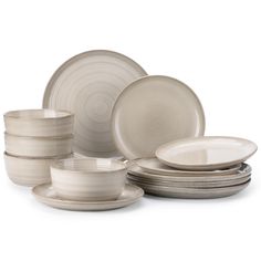 an assortment of white dishes and cups