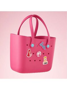 a pink handbag with stickers on it hanging from a hook in the air