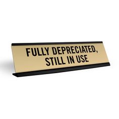 a black and white sign that says fully depreciated, still in use