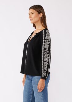 A classic boho blouse with long raglan sleeves and contrast embroidered detail throughout. Embroidered detail Relaxed fit Long raglan sleeve Single-button wrist closure Split v-neckline Bohemian blouse Dry clean recommended or hand wash cold Classically boho for any season, our effortlessly relaxed blouse is crafted from a viscose and linen blend. Featuring contrast embroidered details, long raglan sleeves, and a split v-neckline. Tuck this effortless everyday top into vintage denim and add a cl Casual V-neck Blouse With Embroidered Sleeves, Fall V-neck Blouse With Embroidered Sleeves, Casual V-neck Top With Embroidered Sleeves, Embroidered V-neck Blouse For Fall, Bohemian V-neck Blouse With Embroidered Hem, Bohemian Cotton Blouse With Embroidered Cuffs, Traditional Embroidered V-neck Peasant Top, Long Sleeve Cotton Embroidered Top With Cuffs, Fall Bohemian Split Neck Tops