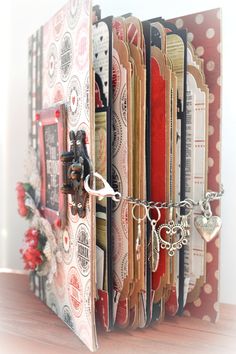 a close up of an open book with lots of cards and key chains on it