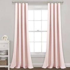 the pink curtain is hanging in front of a window