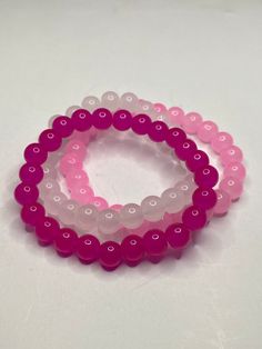 3Pc Pink beaded bracelet set. Includes hot pink, light pink and cloudy white. These bracelets have a shiny glossy look, have a cooling feel and are light weight. The color of the product may look slightly different due to lighting. Pink Friendship Bracelets With 8mm Round Beads, Adjustable Pink Beaded Bracelets With 8mm Beads, Pink 8mm Beads Stretch Bracelet For Friendship, Pink Stretch Bracelet With 8mm Beads For Friendship, Pink Friendship Bracelet With 8mm Beads, Pink Hypoallergenic Beaded Bracelets, Hypoallergenic Pink Beaded Bracelets For Friendship, Pink Crystal Bracelet With Colorful Beads For Friendship, Pink Round Beaded Bracelets For Friendship