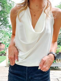 Ivory Satin Halter Top with a cowl neckline and fully adjustable straps for complete coverage. A simple way to add a sophisticated piece to your wardrobe. Chic Cowl Neck Halter Top, Elegant Spring Tops With Cowl Back, Elegant White Spaghetti Strap Halter Top, Elegant White Halter Neck Tank Top, Elegant Cowl Neck Tank Top For Night Out, Chic White Halter Top, Chic White Halter Camisole Top, Fitted Chic Tank Top With Cowl Back, Chic Fitted Tank Top With Cowl Back