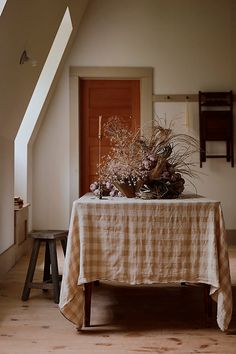 a table with a checkered cloth on it is in the middle of an upstairs room