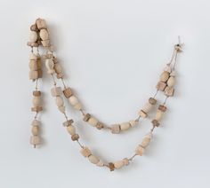 a necklace with wooden beads hanging from it's sides