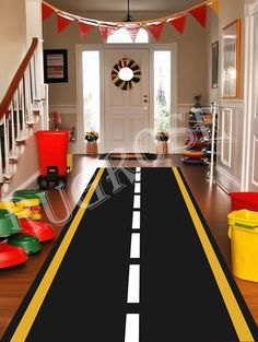 a hallway with a black and yellow striped road leading to the front door is shown