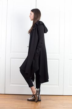 "Wool Cape, Knit Cardigan, Cloak with Hood This asymmetrical and modern cloak with hood has two side pockets, super comfy hood and thumb holes for a fabulous look. The model in the picture is 168cm. ⅼ 5.6 ft. tall and is wearing size S / color: black 🌟 INFO: * Worldwide EXPRESS shipping - please provide a phone number for shipping documents * US Sizing XS to 4XL - body size chart available below * We offer customization to Personal Measurements & Larger Sizes 5XL, 6XL, 7XL .... 🌟 MATERIAL Cozy Long-sleeve Winter Cape, Cozy Long Sleeve Winter Cape, Oversized Hooded Outerwear For Layering, Cozy Winter Cape, Cozy Cape Cardigan For Fall, Black Cape Cardigan For Winter, Winter Long Sleeve Cape For Layering, Oversized Hooded Cardigan For Fall, Long Sleeve Winter Cape For Layering