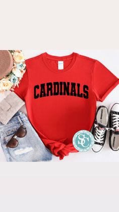 These Cardinals varsity shirts are a perfect addition to your school spirit wear and are super cozy!  ❗️Sizes: Toddler-2T-5T  Youth XS-XL  Adult S-XL  Adult 2X Adult 3X Available in short sleeve, long sleeve and sweatshirts!  Shirts are all unisex sizing!  The shirt has cardinals printed and pressed onto the shirt! Cardinals is written in distressed black vinyl!  If you would like to request a custom order, please send us a message!! Cardinals Spirit Wear, Collegiate T-shirt With Lettering For College, Red Varsity T-shirt For Sports Season, Casual T-shirt With Lettering For Fans, Casual T-shirt With Lettering For Game Day, School Spirit T-shirt With Lettering For College, Red Varsity Tops For Fan Gear, Casual T-shirt For School Football Season, Collegiate Tops With Team-colored Lettering