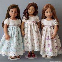 three dolls are standing next to each other