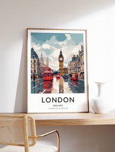 the london poster is hanging on the wall next to a chair and table with a vase