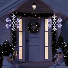 lighted snowflakes on the front door of a house