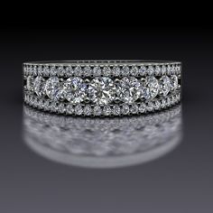 three stone diamond wedding ring set in white gold with diamonds on the band and side stones