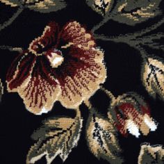 a close up view of a flower on a black background with red and white flowers