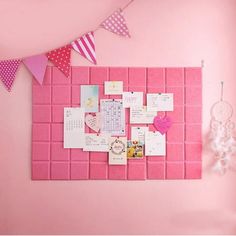 a pink bulletin board with pictures and hearts on it