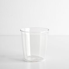 a clear glass cup sitting on top of a white table