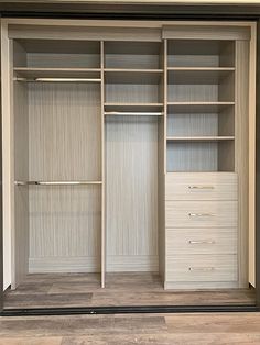 an empty walk in closet with two drawers and one door open to the other side